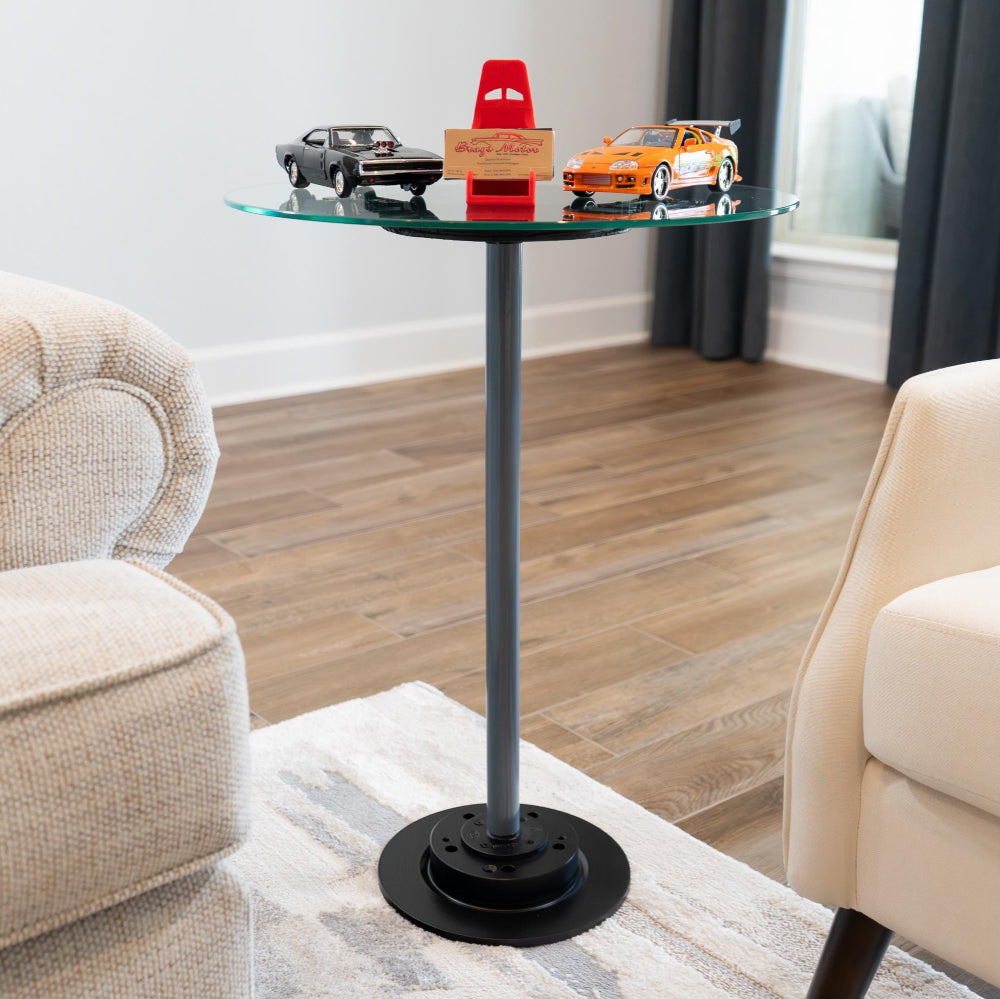 Small glass table with toy cars on a living room floor