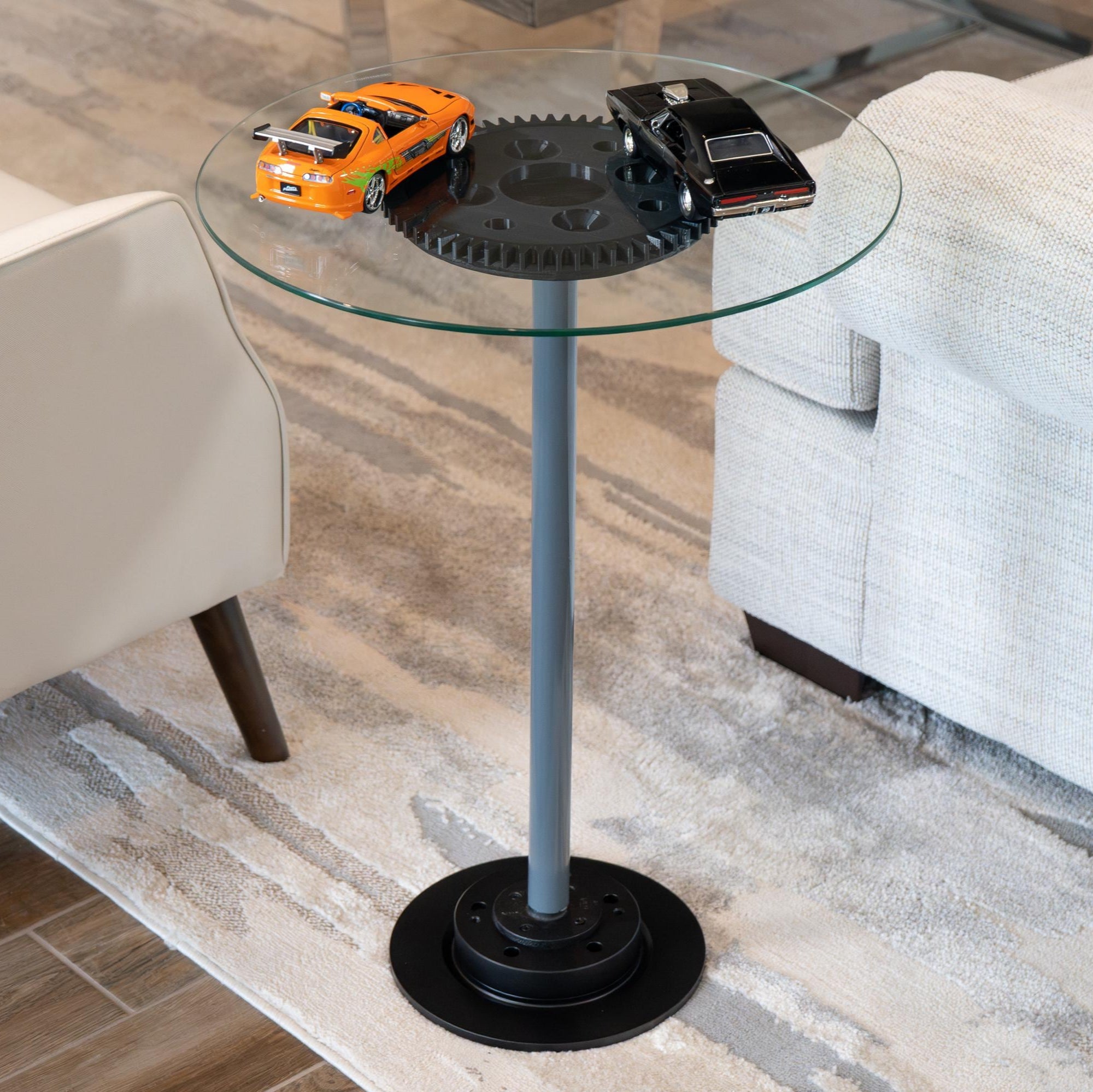 Glass side table with black metal base in a living room setting