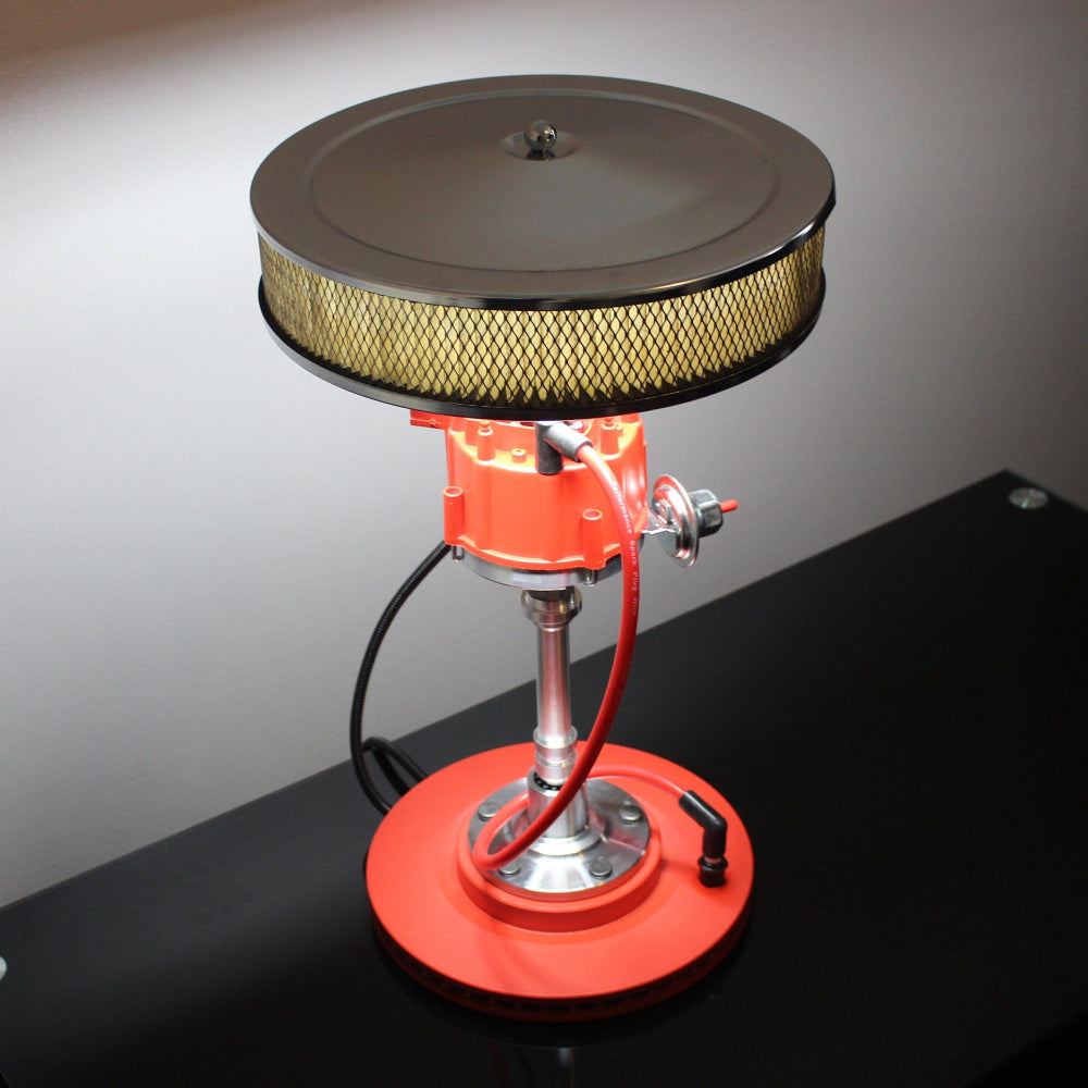 Innovative lamp design with air filter and red base on a dark surface