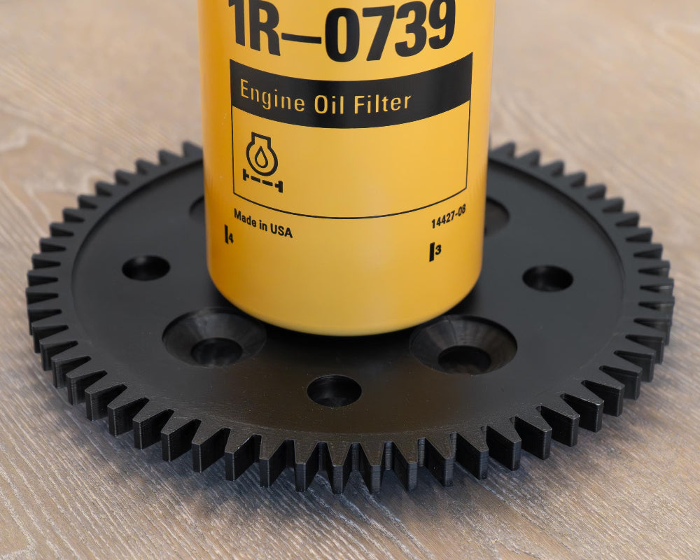 Engine oil filter with gear on a wooden surface