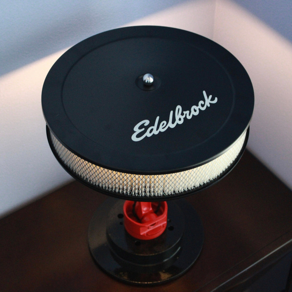 Edelbrock air filter on a stand against a neutral background