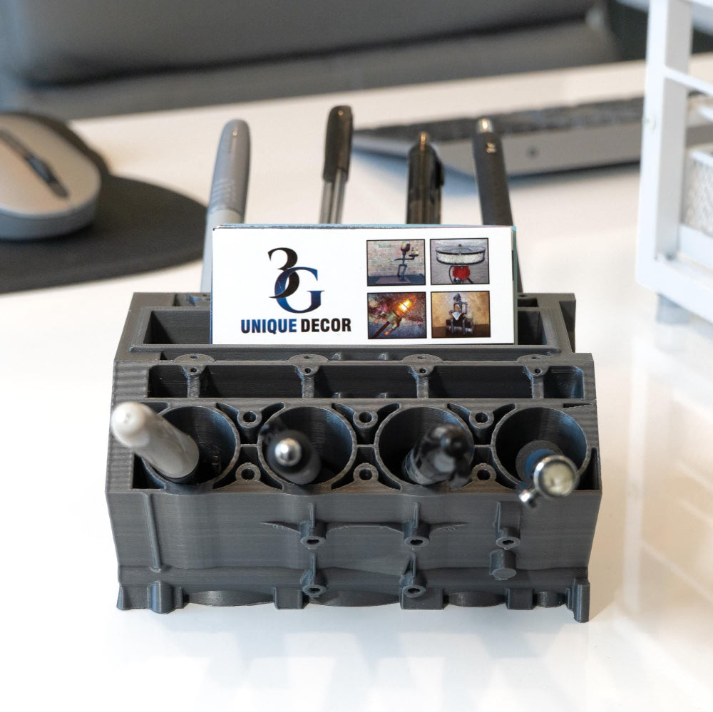 Black decorative item with a card labeled 'Unique Decor' on a desk.