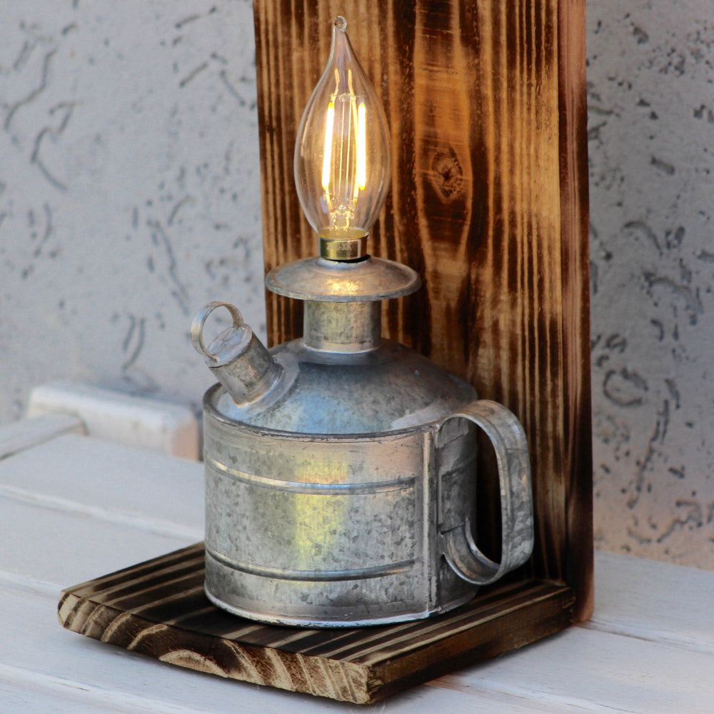 Vintage-style oil lamp on a wooden base with a textured wall background
