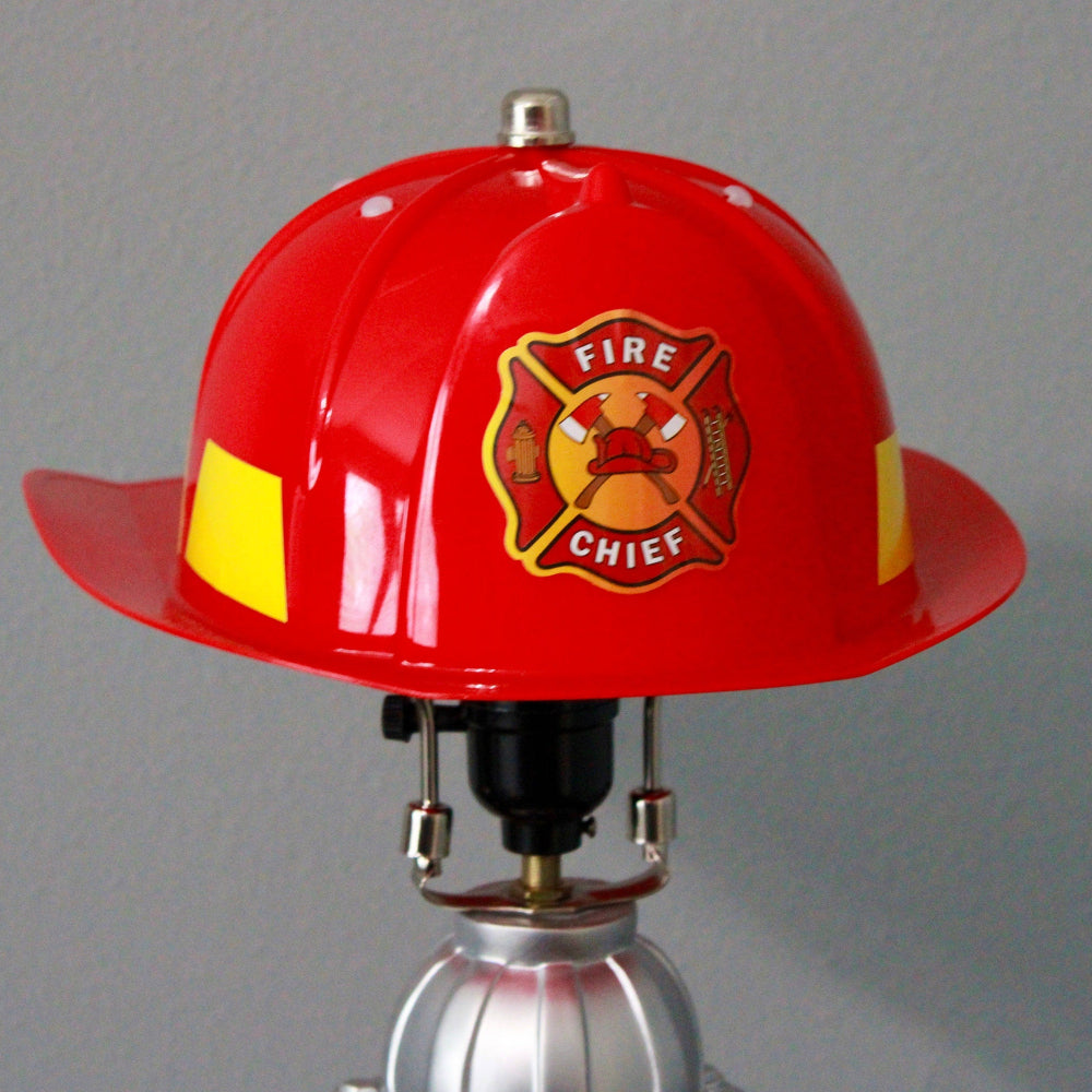 Red fire helmet with a 'Fire Chief' emblem on a gray background