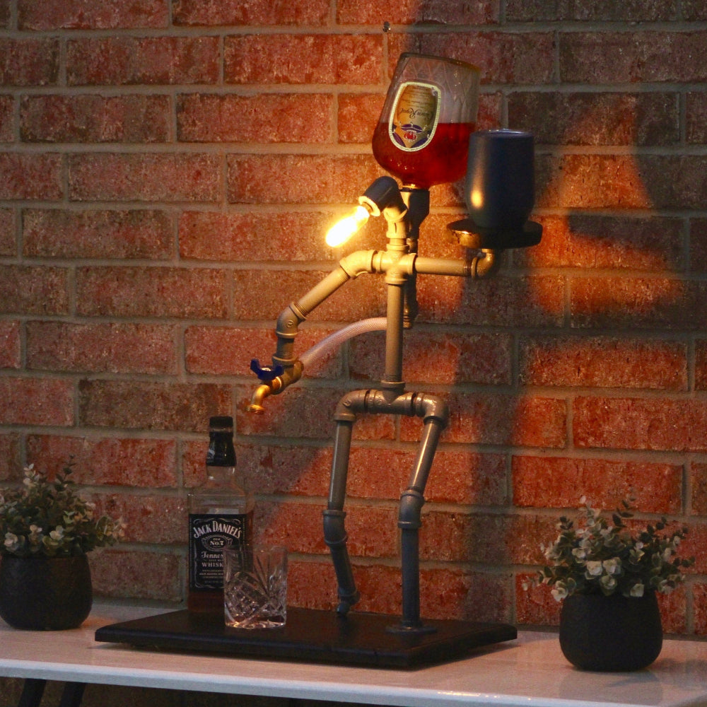 Pipe-themed lamp with a bottle of Jack Daniel's on a brick wall background