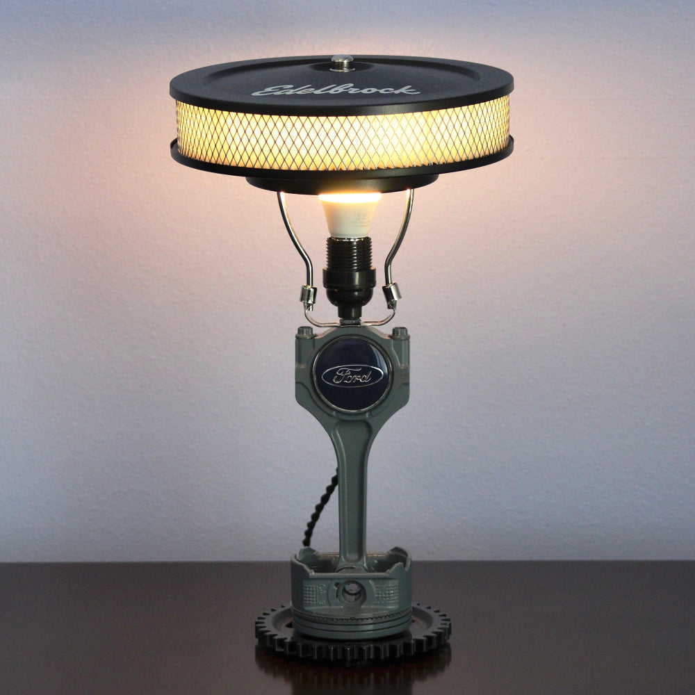 Ford branded lamp with vintage design on a dark surface against a light background
