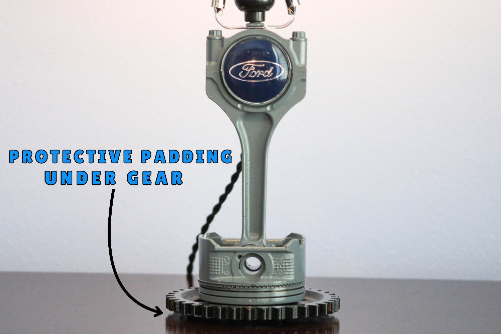 Ford engine block lamp with protective padding under gear labeled on a white background