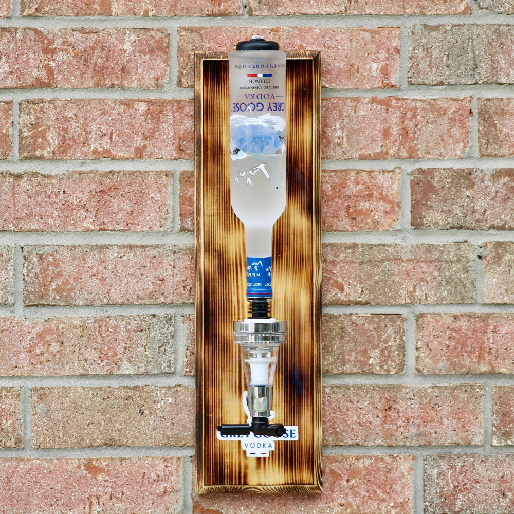 Wooden wall-mounted dispenser with water bottles on a brick wall