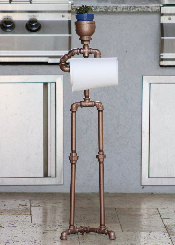 Copper pipe stand with a roll of paper towels in a kitchen setting
