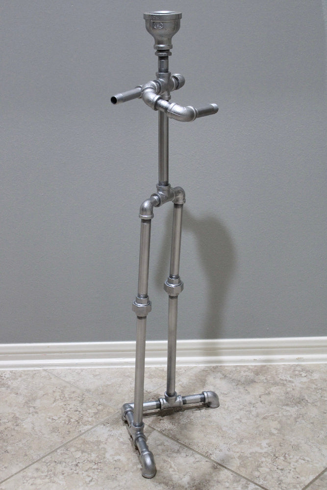 Metal stand with pipes against a gray wall