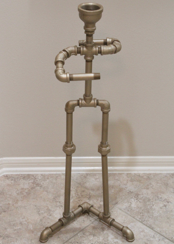 Decorative stand made of metal pipes against a plain wall.