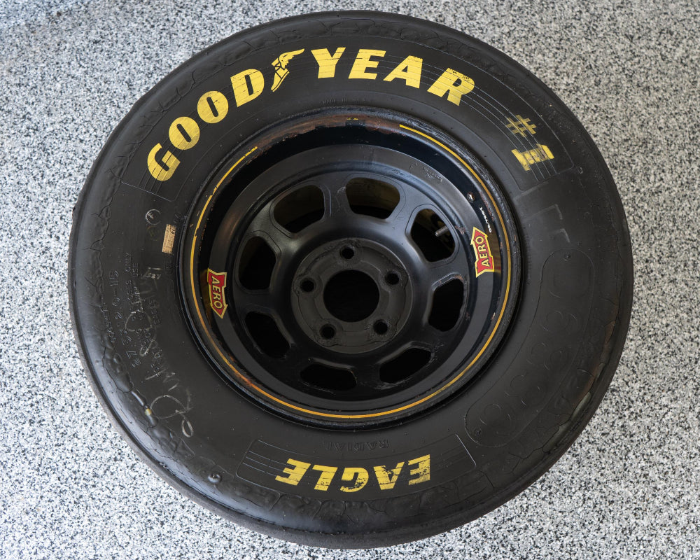 Goodyear tire on a textured gray surface