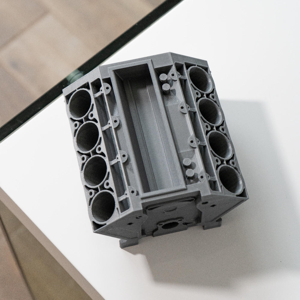 Gray plastic component on a white surface