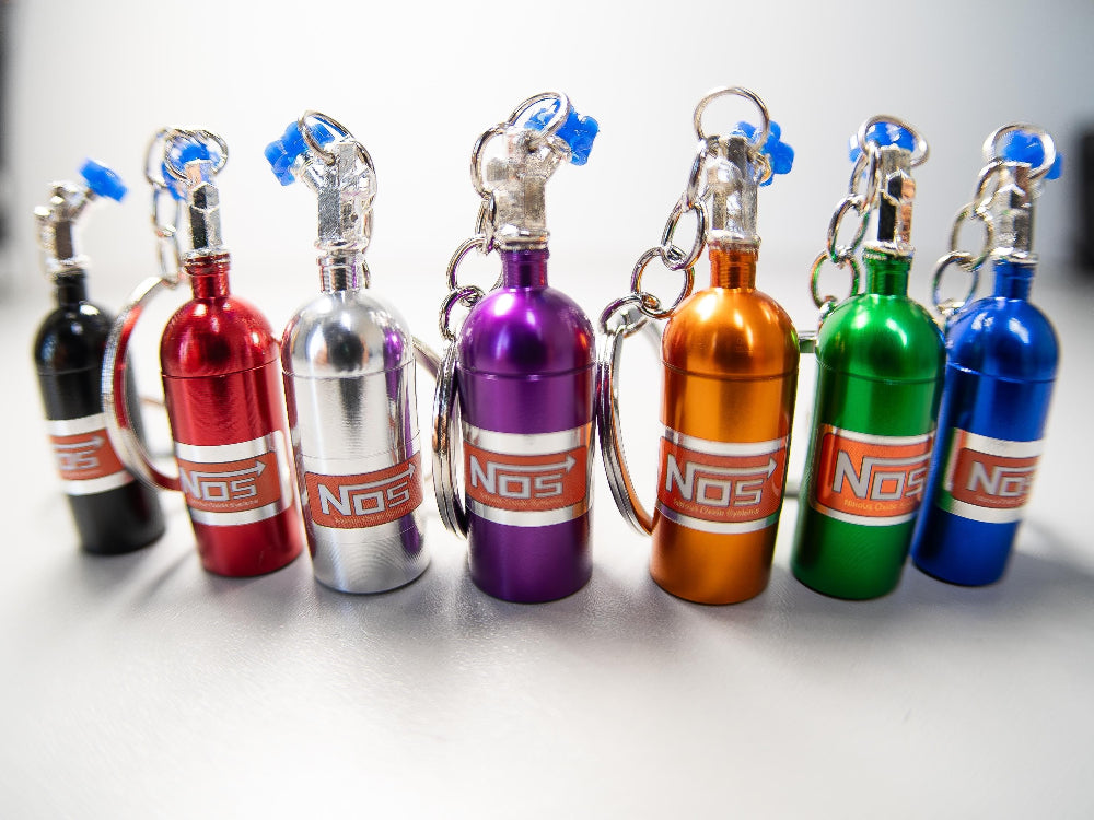 Set of colorful NOS bottle keychains on a white background