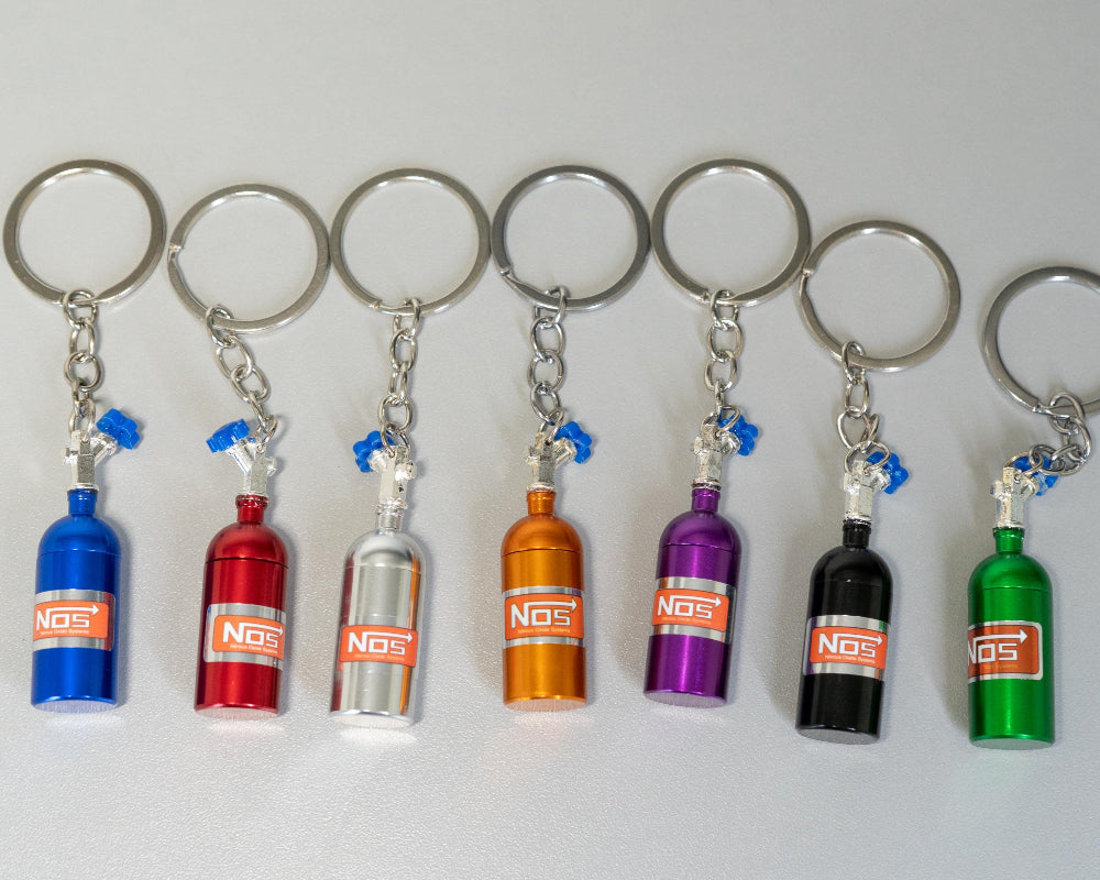 Set of colorful NOS bottle keychains on a white background
