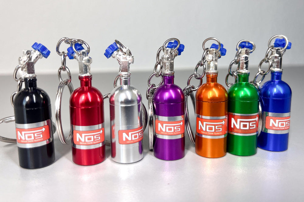 Set of colorful NOS bottle keychains on a white background