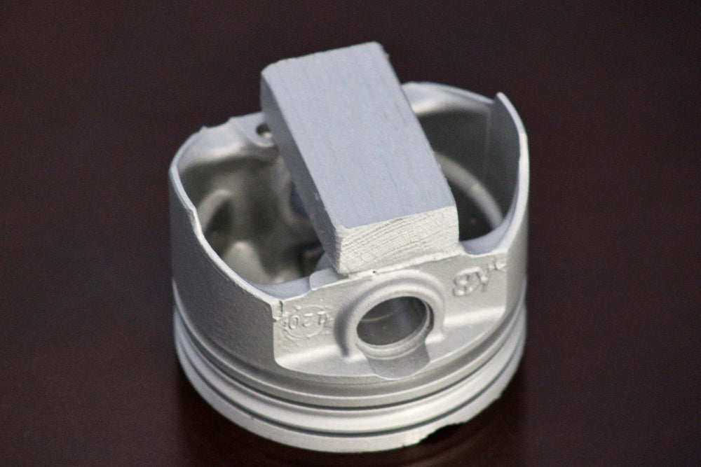 Metal piston on a dark background