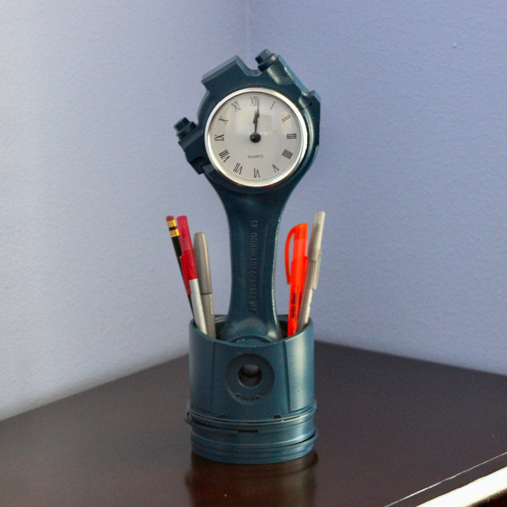 Desk organizer with clock and pen holder on a wooden surface