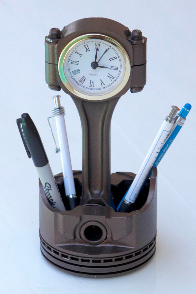 Piston-shaped pen holder with clock on a white background