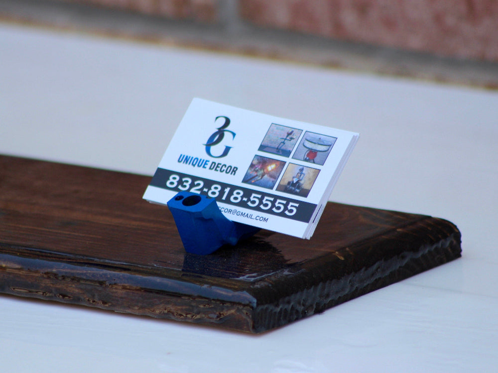 Business card holder with a business card on a wooden surface