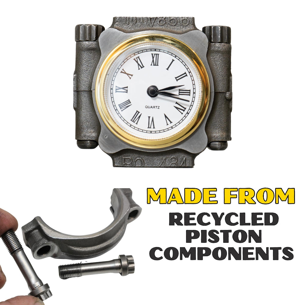 Clock made from recycled piston components with text on a white background