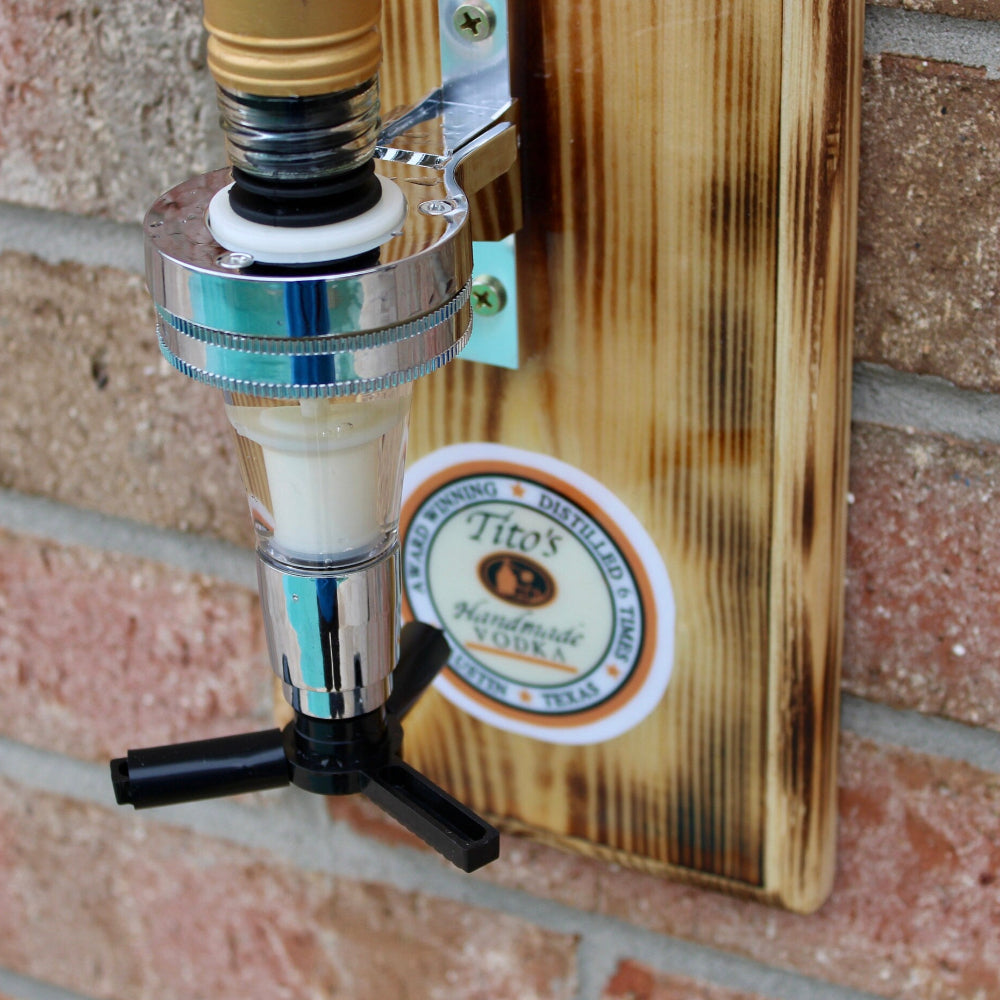 Wall-mounted beer tap with wooden plaque on a brick wall