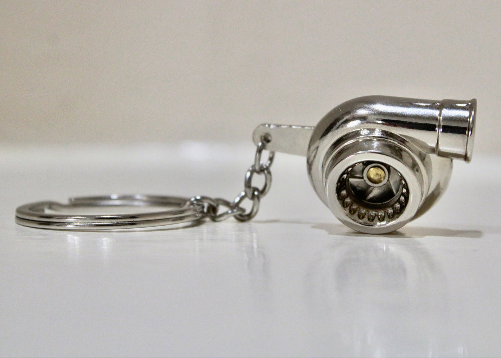 Turbocharger keychain on a white surface
