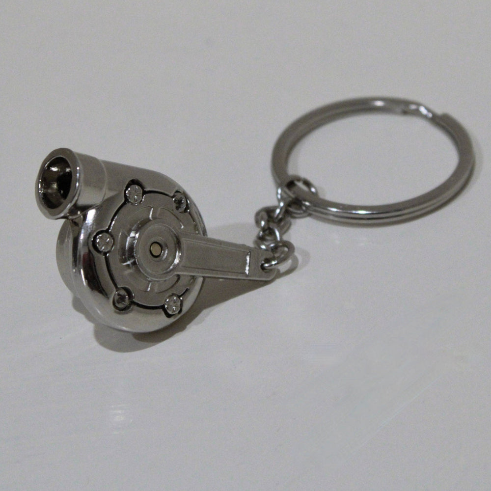Metallic turbocharger keychain on a white background