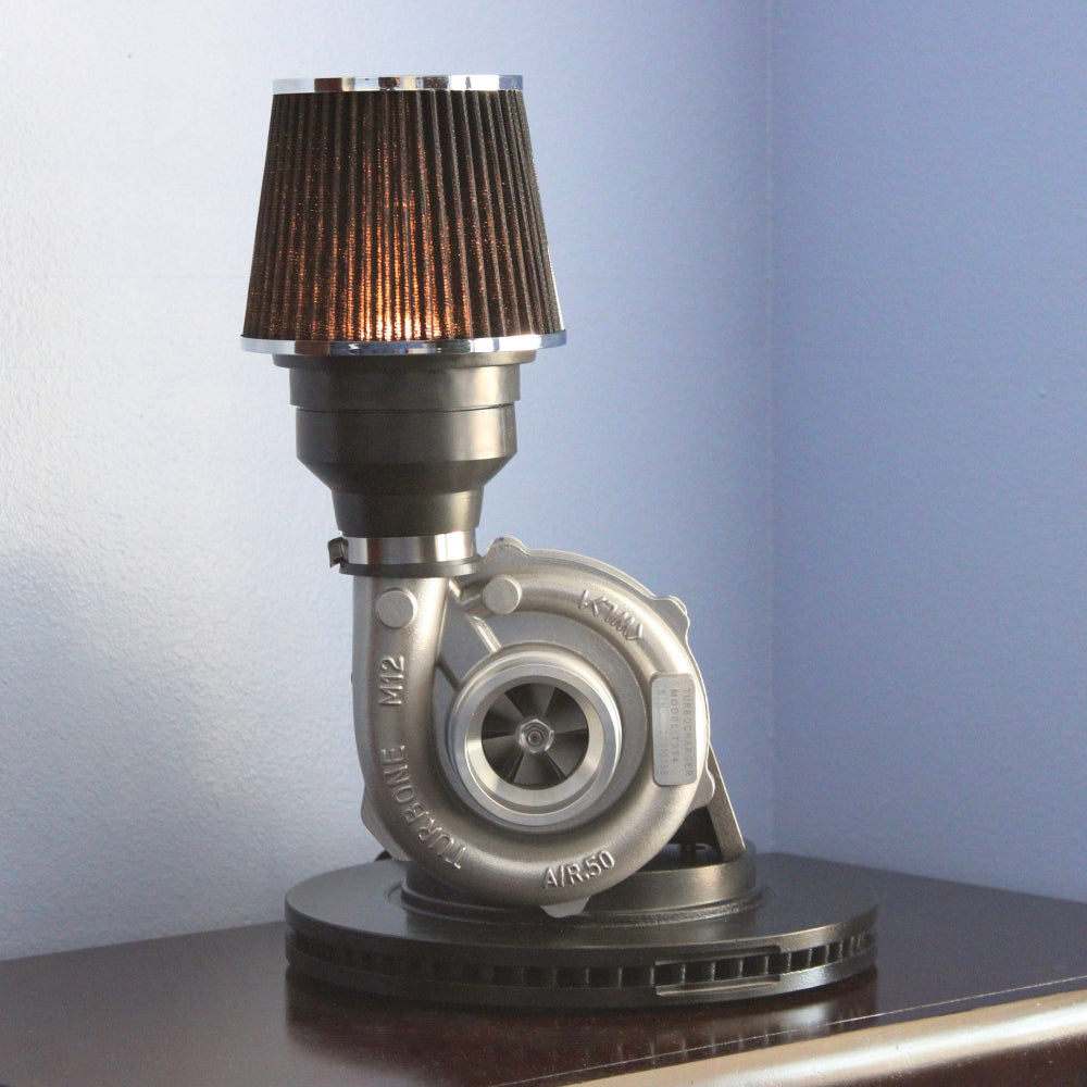 Turbocharger lamp with a brown shade on a reflective surface