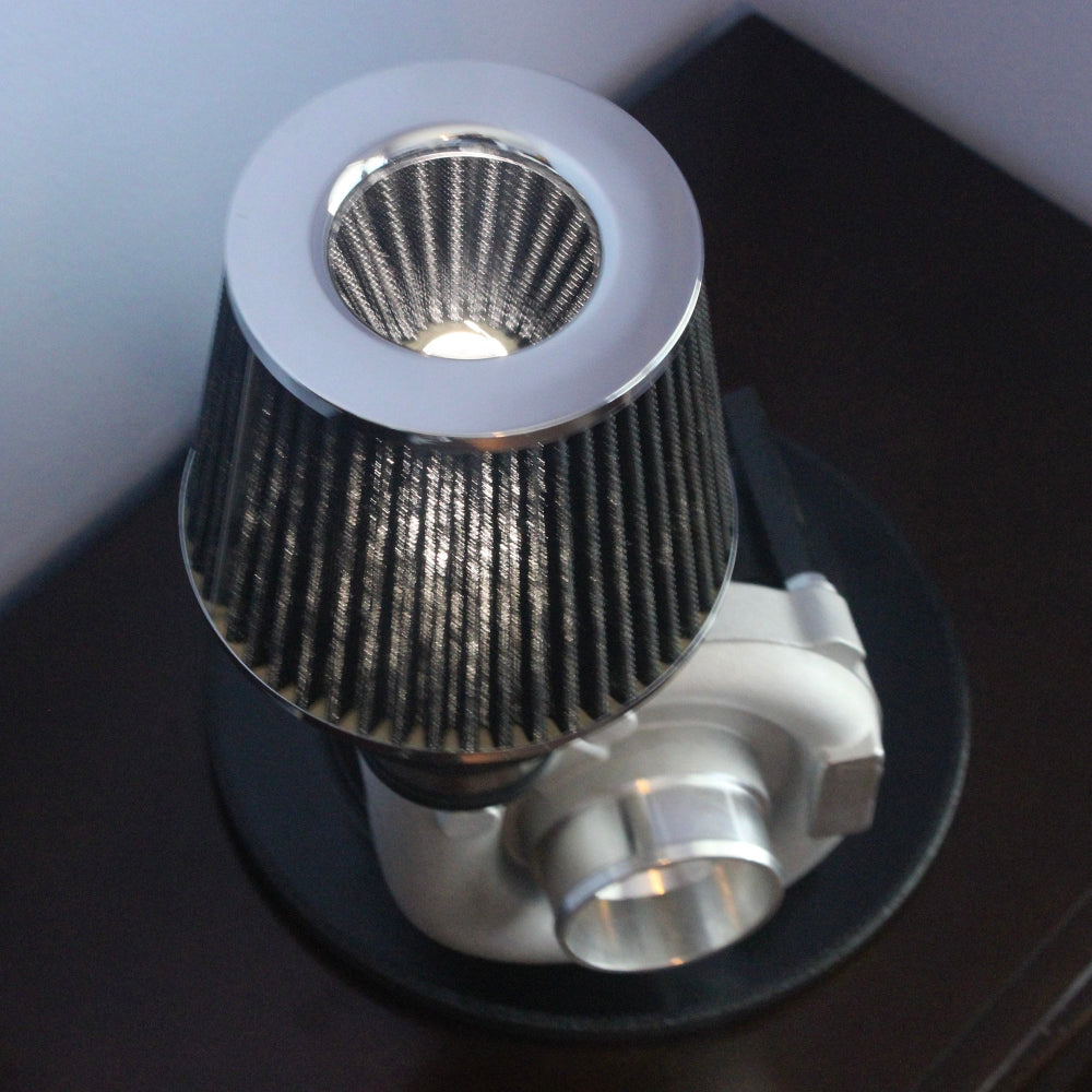 Metallic shower head on a dark surface with a neutral background