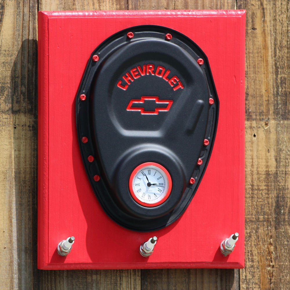 Red and black Chevrolet clock on a wooden surface