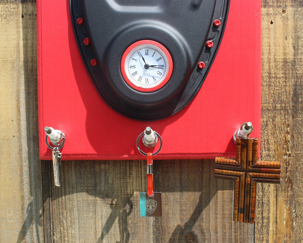 Red clock with key holders on a wooden surface
