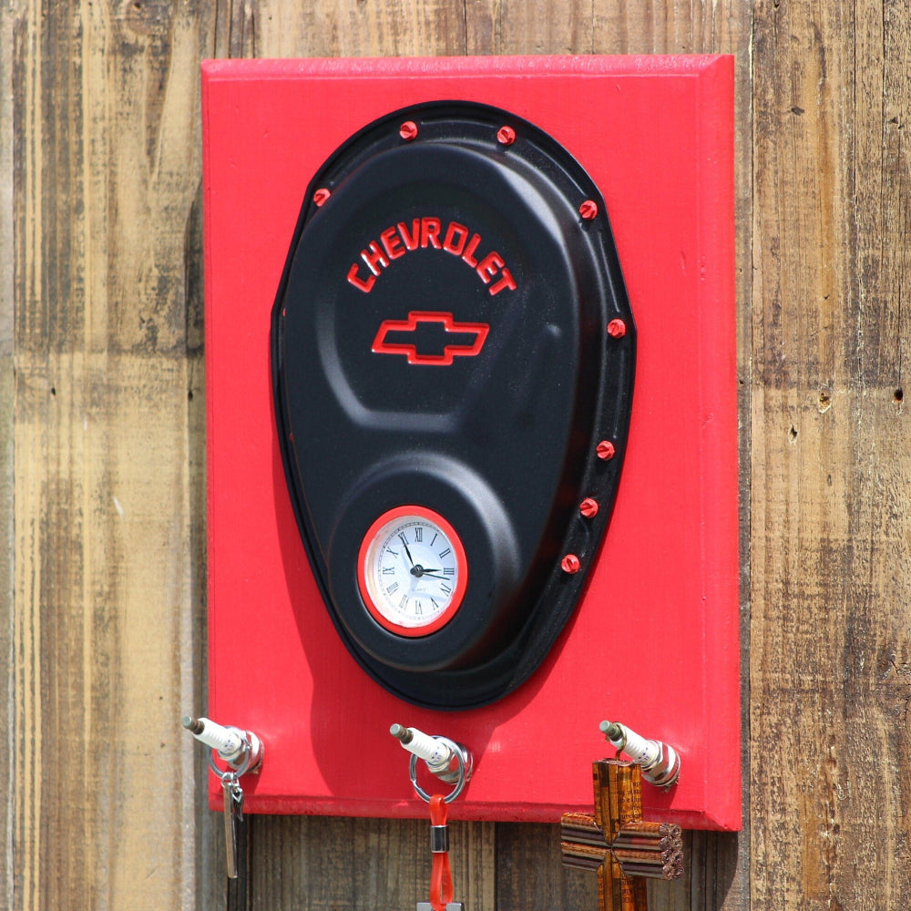 Red and black wall clock with Chevrolet logo on a wooden background