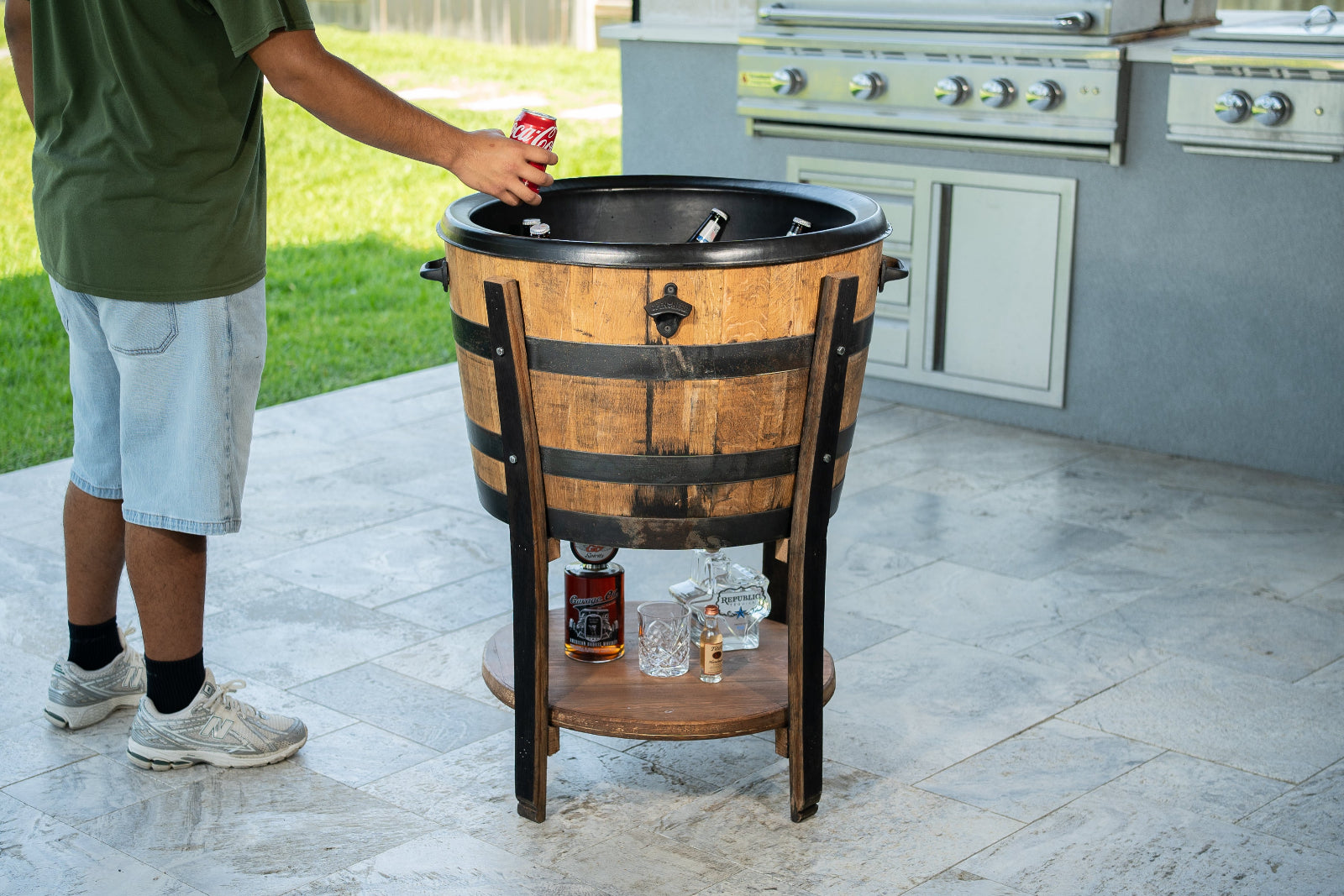 3G Unique Decor handcrafted whiskey barrel cooler cart with ice tub basin and lower liquor shelf on an outdoor patio.