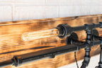 Wooden wall with industrial-style light fixture featuring a visible bulb.