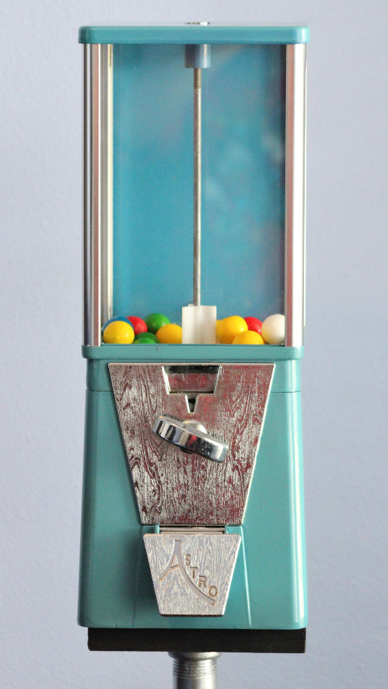 Vintage-style gumball machine with colorful gumballs on a gray background