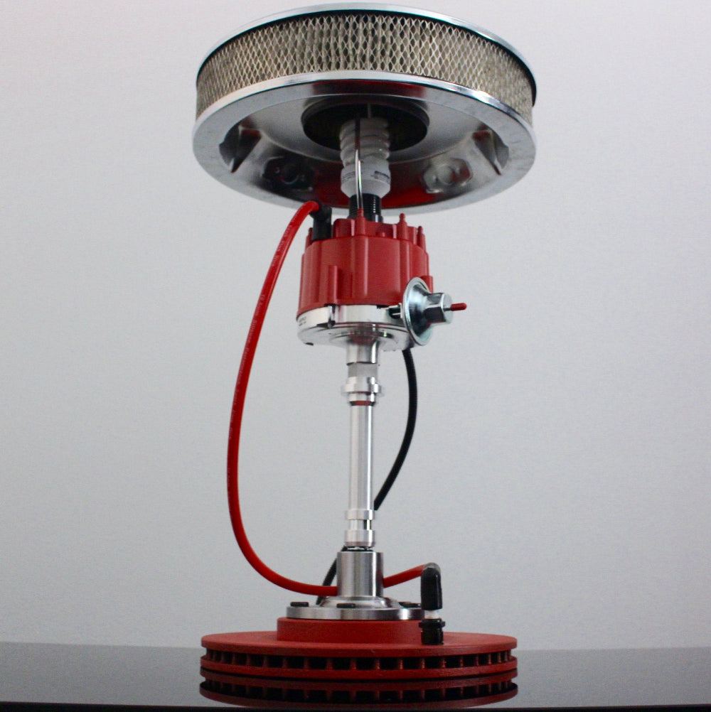 Mechanical component with red and silver design on a gray background