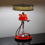Lamp designed like a red engine block on a gray background