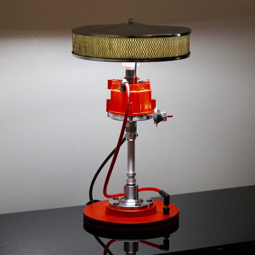 Lamp designed like a red engine block on a gray background