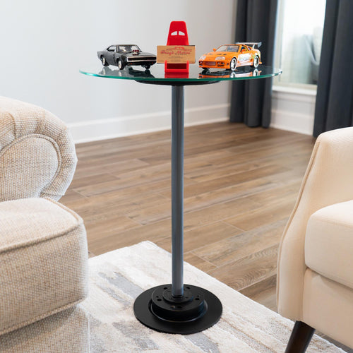 Small glass table with toy cars on a living room floor