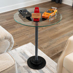 Glass side table with toy cars on a wooden floor in a living room setting