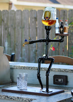 Beverage dispenser shaped like a skeleton with drinks on a patio