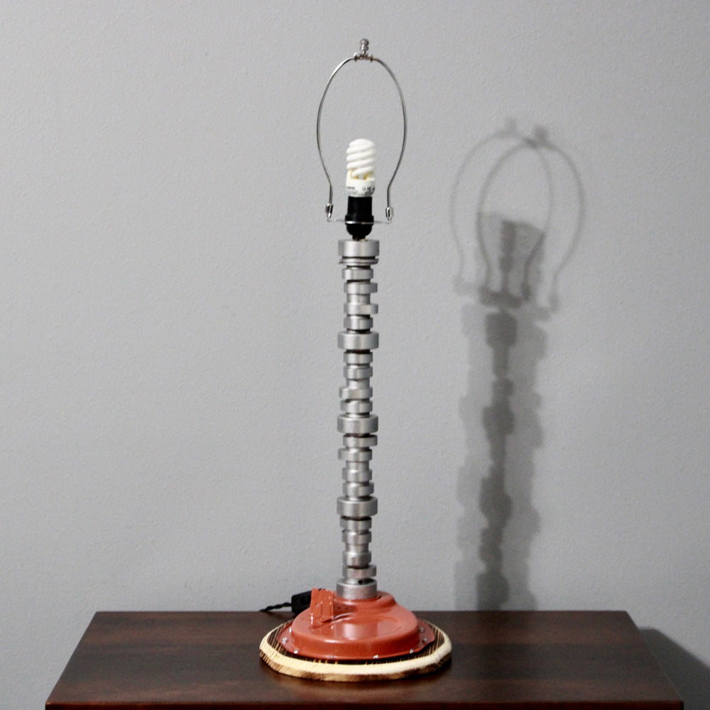 Table lamp with unique design on a wooden surface against a gray wall