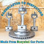 Metal engine parts with 'Sandblasted to Perfection' text against a wooden background