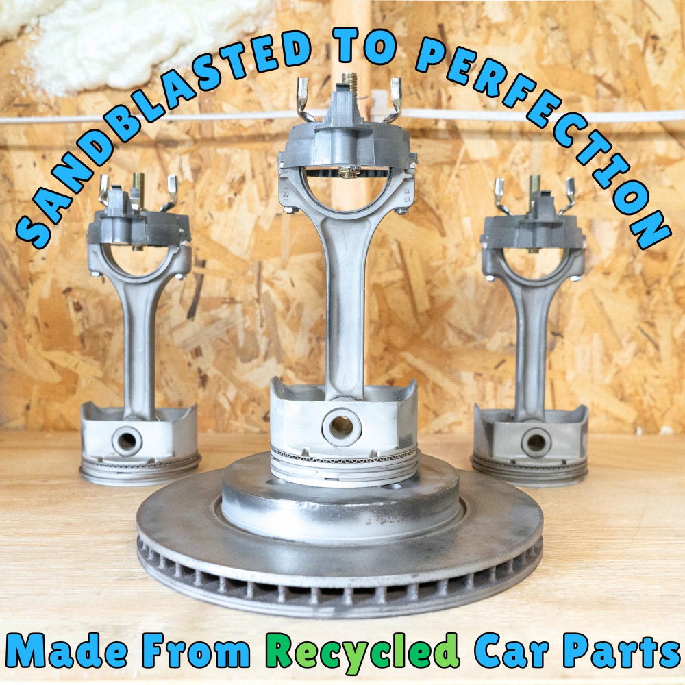 Metal engine parts with 'Sandblasted to Perfection' text against a wooden background