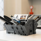 Black office supply organizer with stationery items on a desk