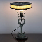 Vintage-style table lamp with a unique design on a dark surface.