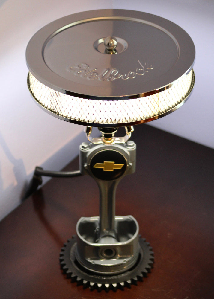 Metallic lamp with gear design on a wooden surface