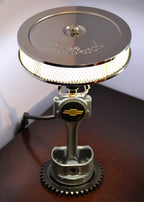 Metallic lamp with gear design on a wooden surface