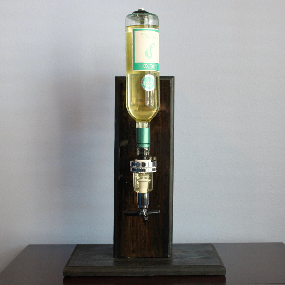 Bottle of white wine on a wooden stand against a gray background